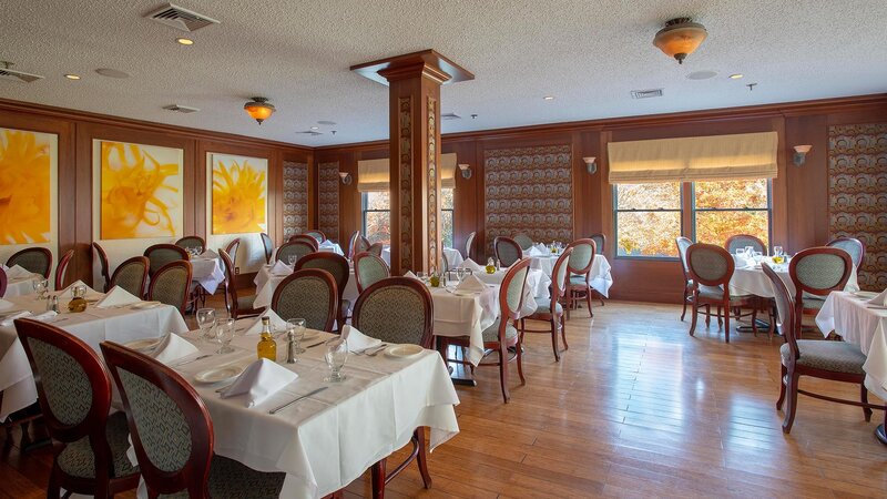 Private dining room with long tables set for many guests